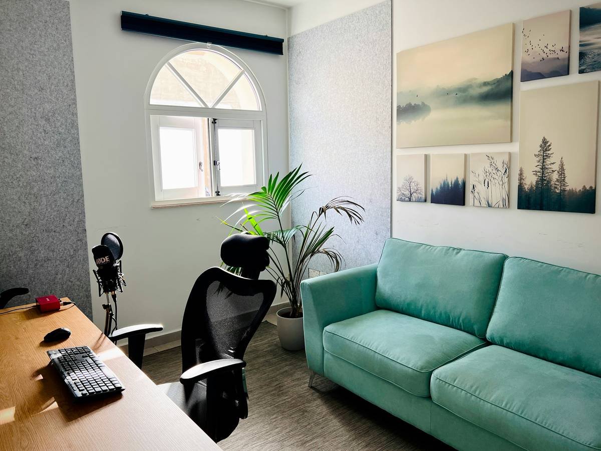 Modern workspace at FlippingBook with a cozy sofa, desk setup, and soft natural light, creating a calm and productive office environment.