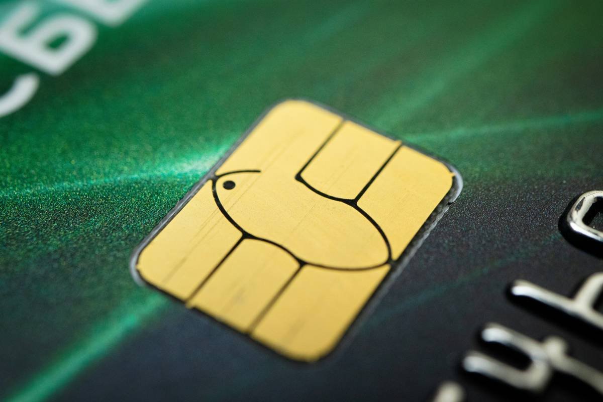 Woman holding credit card and return shipping label during card return claim process